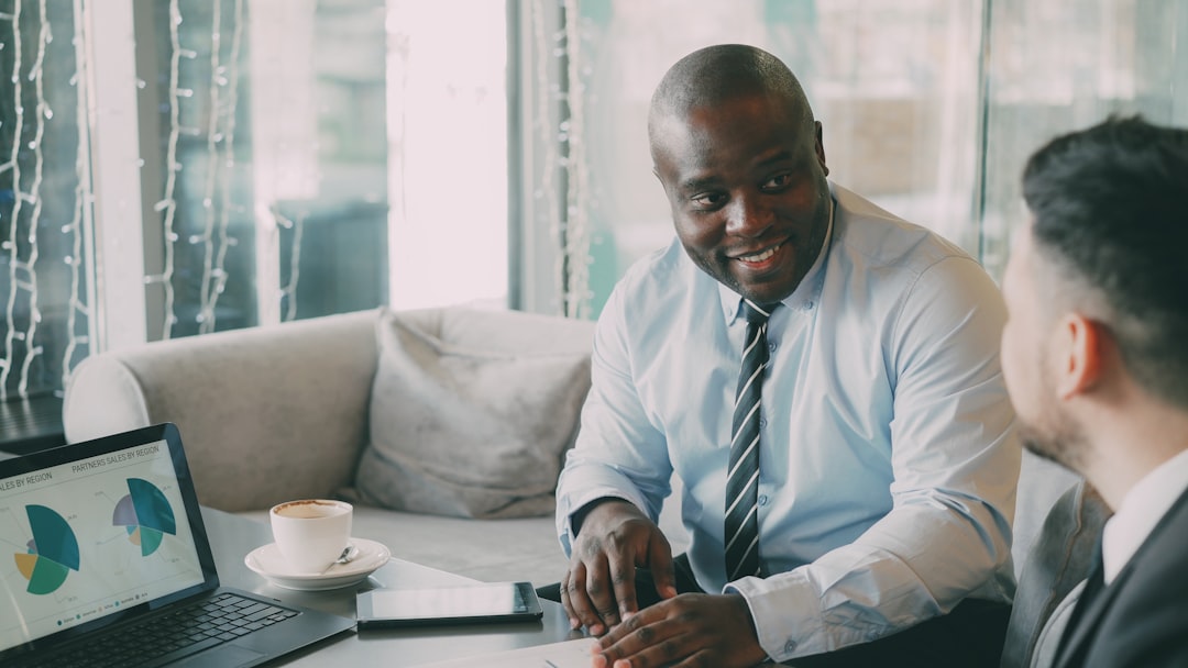 Two businessmen in a meeting with laptop and laptop.